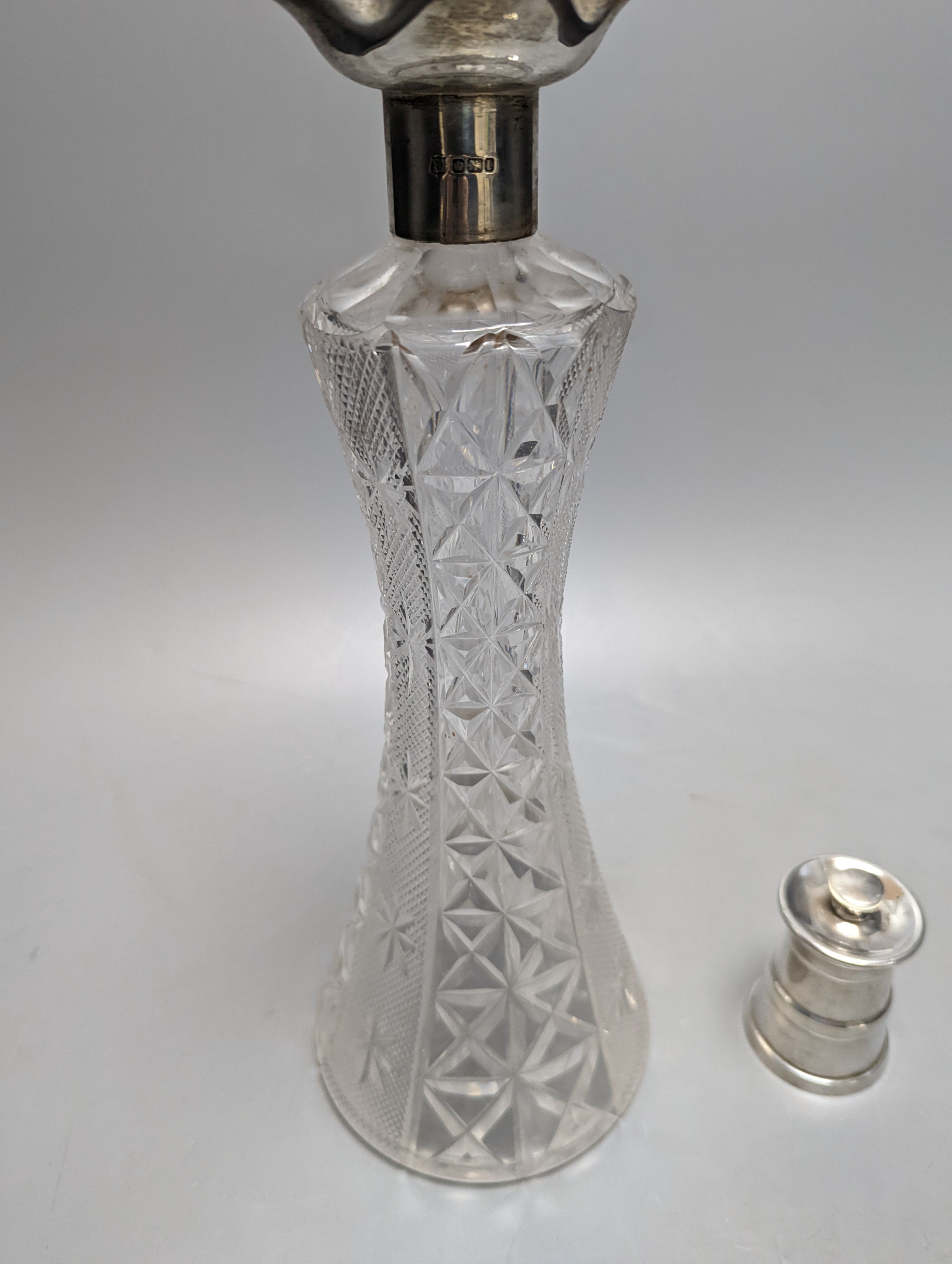 An Edwardian silver mounted cut glass decanter, Sheffield, 1903, 36cm and silver mounted pepper mill.
